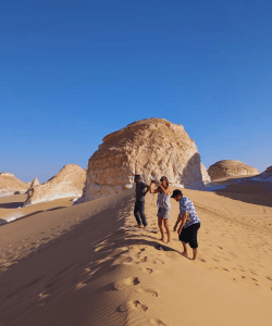 Happy guests exploring the White Desert with Sahara Egypt Tours
