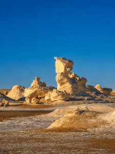 Eroded hoodoos under a golden sky