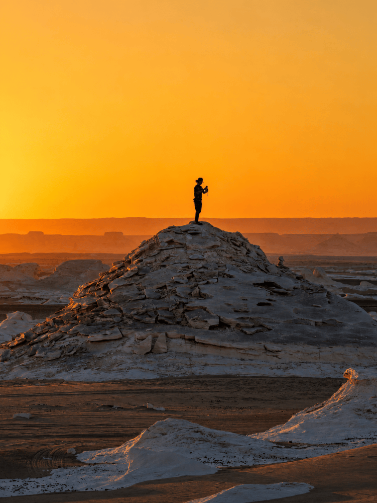 Solitary explorer in desert sunset
