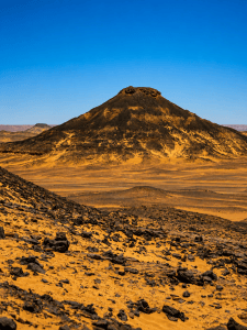 Volcanic hill in desert landscape